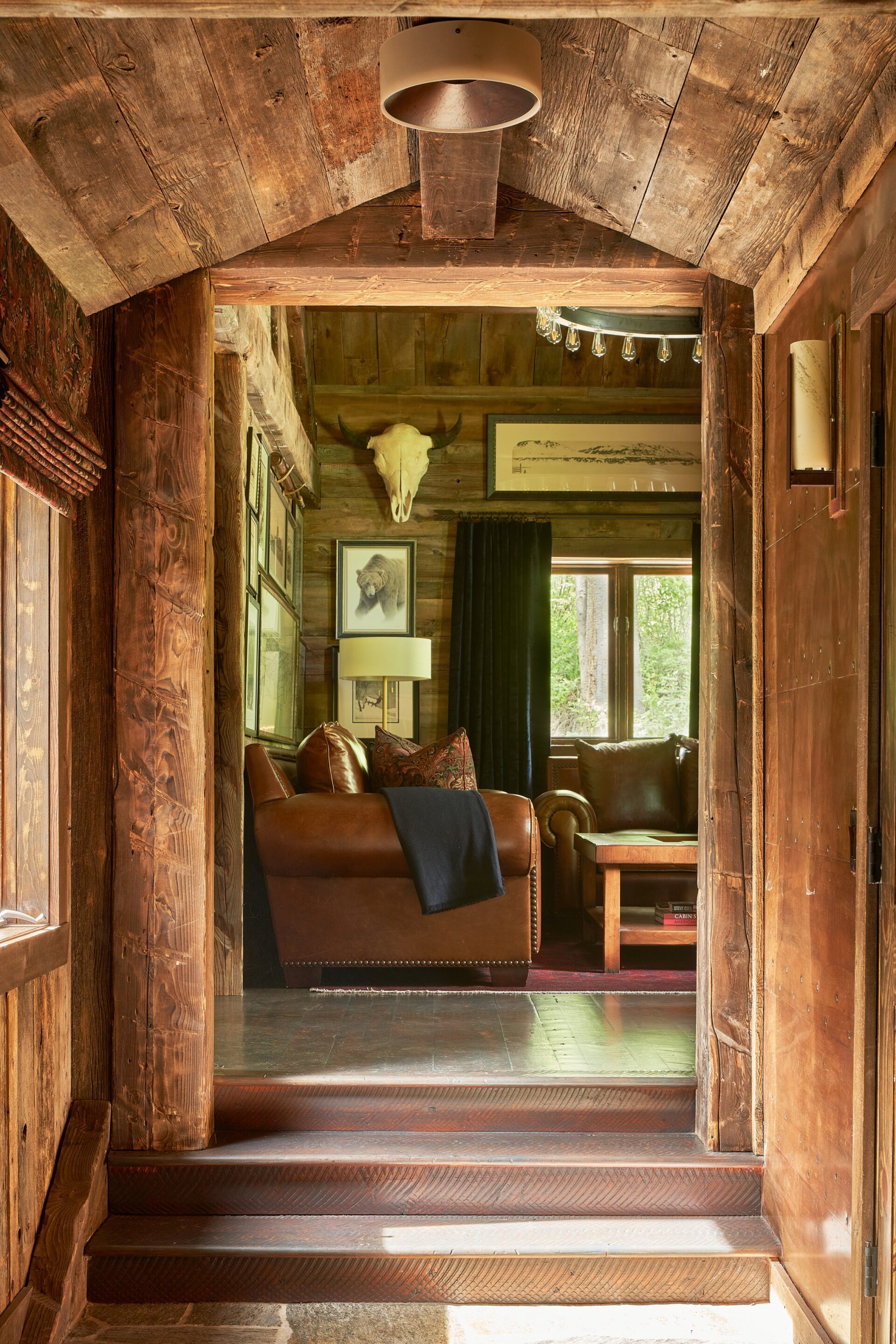 View down the hallway into living room with leather furniture