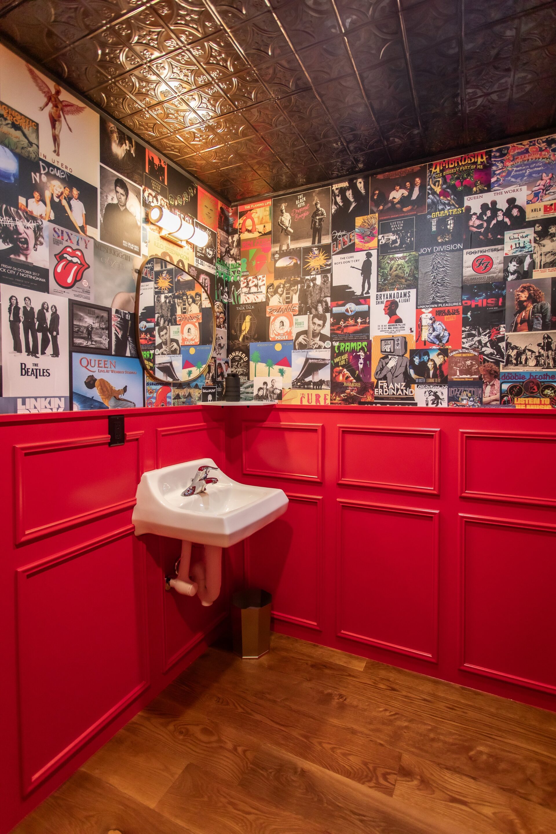 Postered wall in The Bunker bathroom