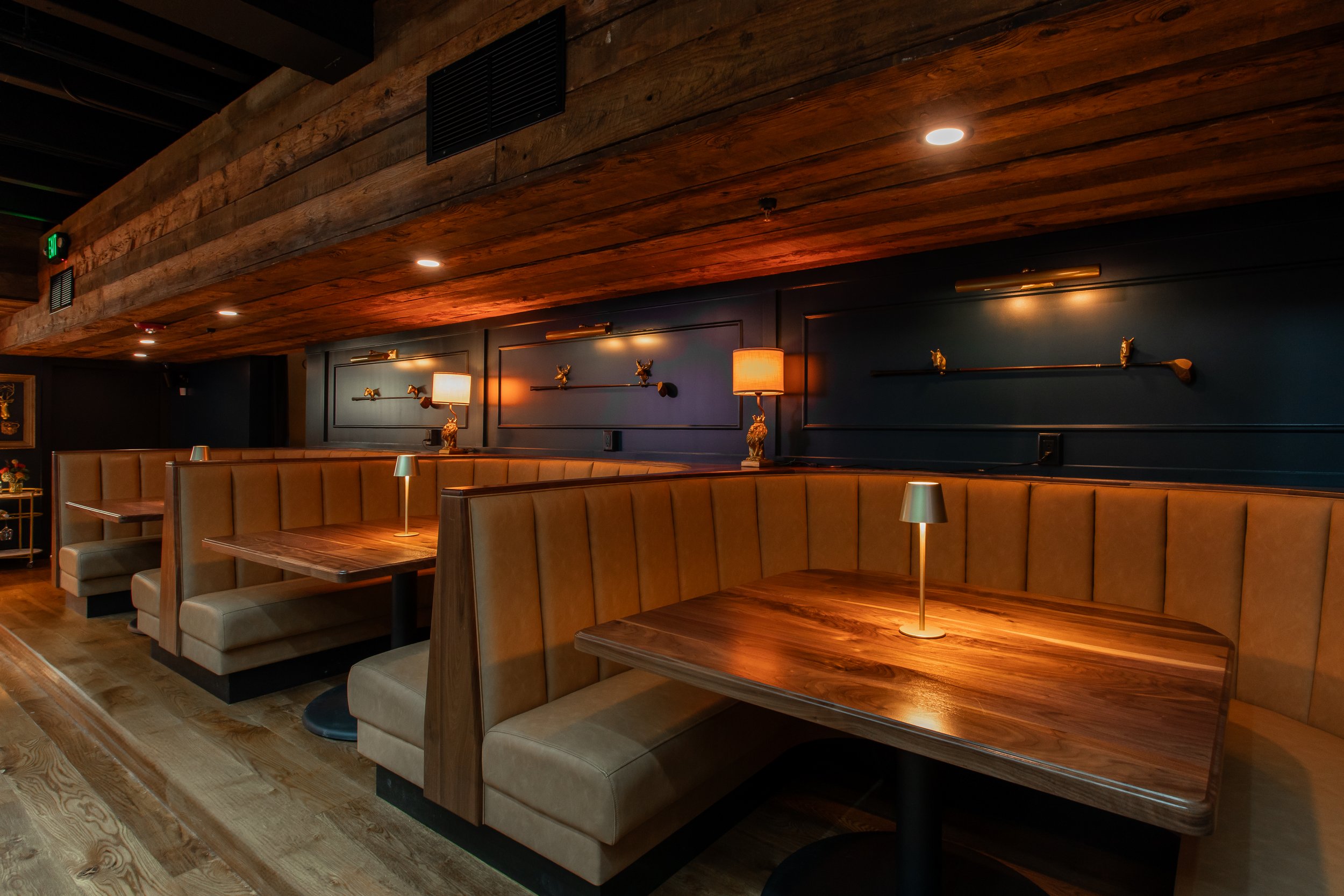 Booths with dark, warm lighting in The Bunker