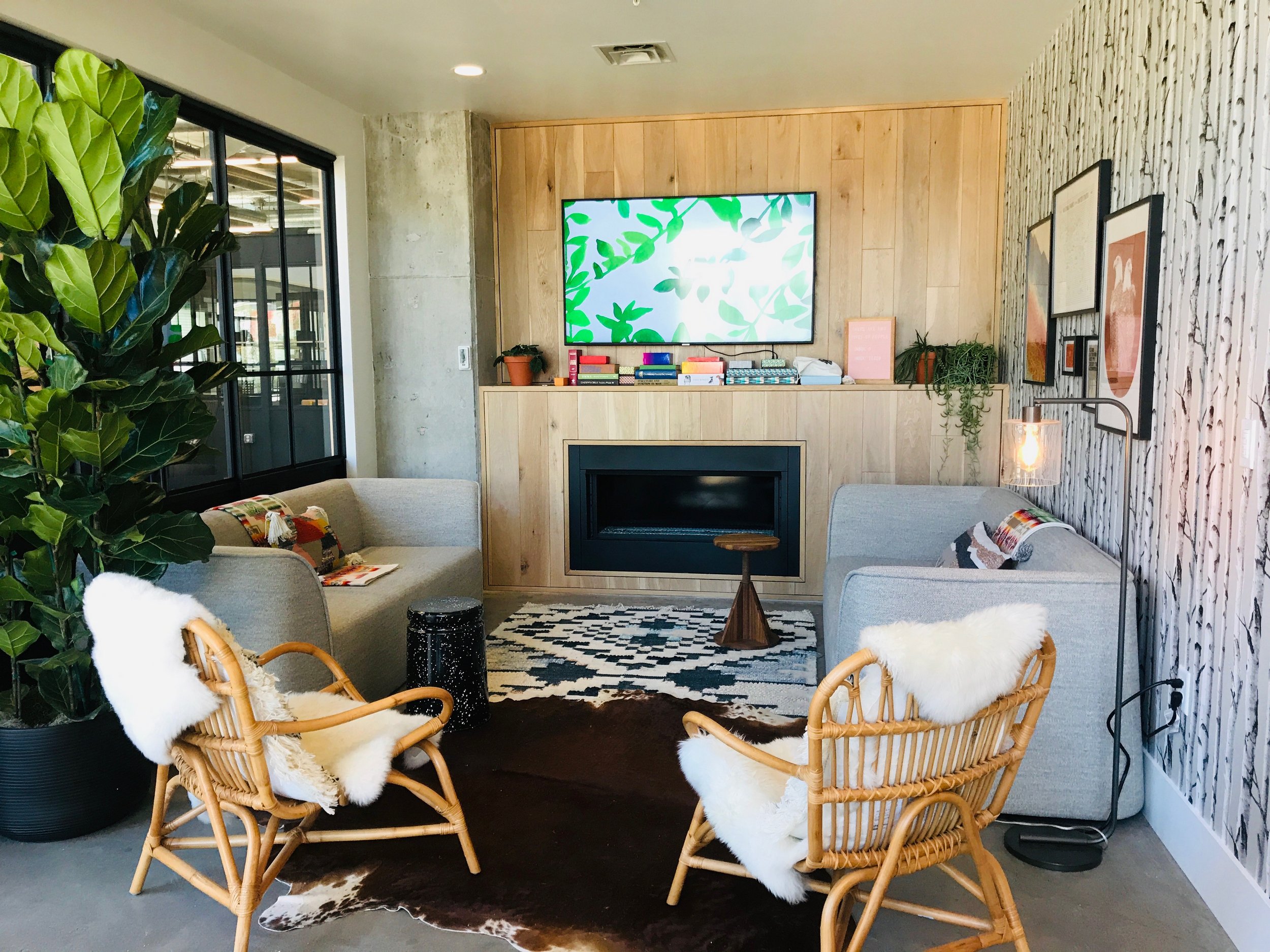 Cozy lounge room with couches, chairs and electric fireplace