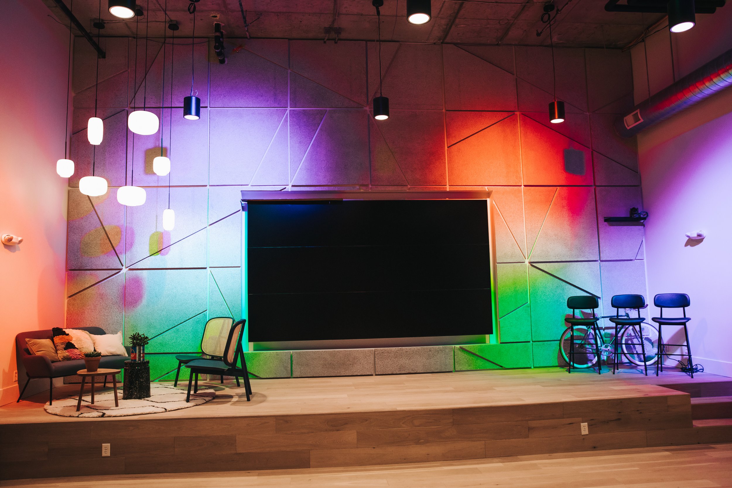 Lounge room with colorful lights and seating areas